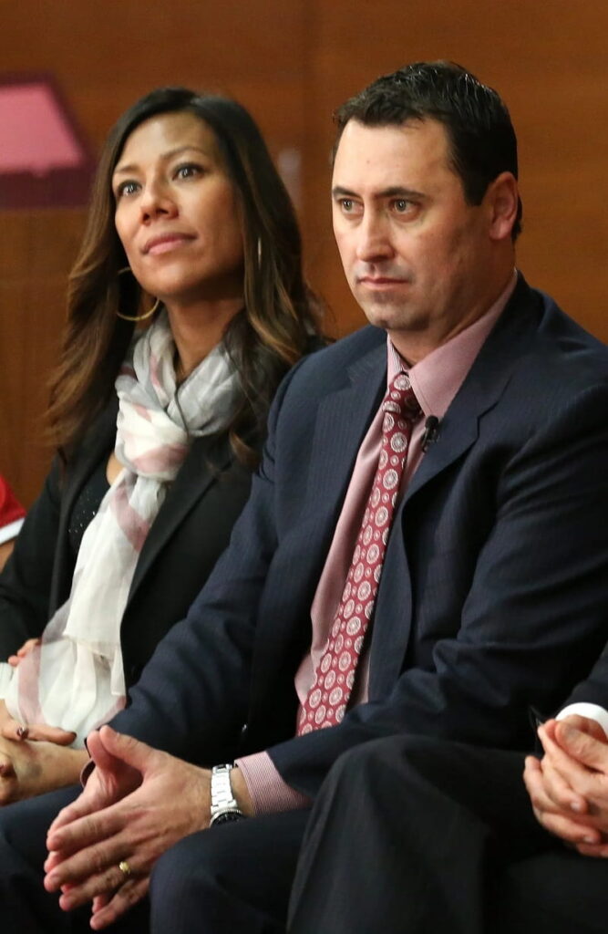 Steve Sarkisian sits with his wife Stephanie at a press conference introducing him as the new USC head football coach at the John McKay Center at the University of Southern California on December 3, 2013 in Los Angeles, California.