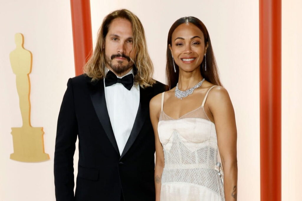 Marco Perego and Zoe Saldana attend the 95th Annual Academy Awards.